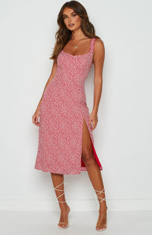 Red midi dress with white floral print, square back, ruffled shoulder straps, and side split