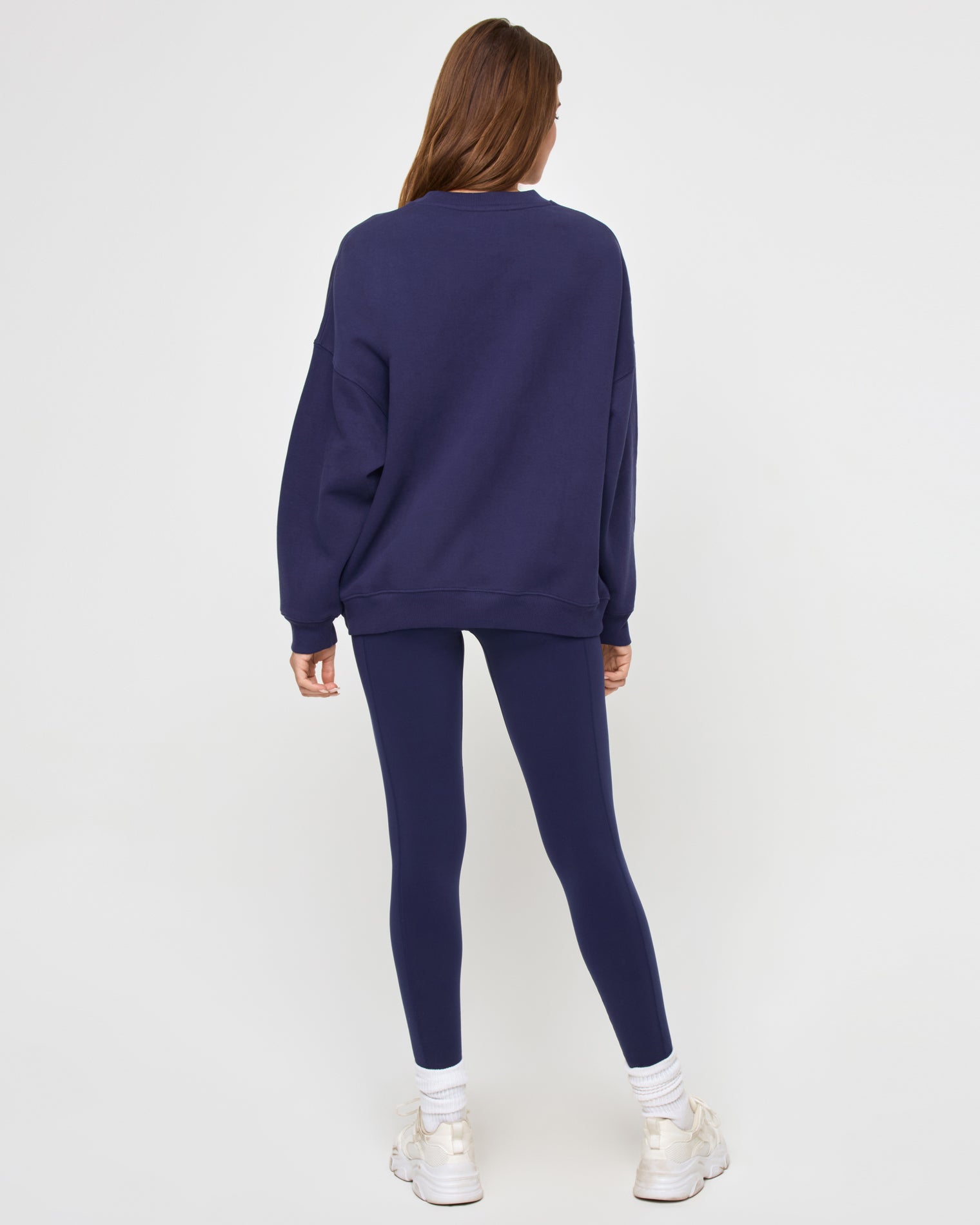 Back view of the LSPACE Legend Sweatshirt in midnight blue on a model against a light background, showing the oversized sweatshirt.