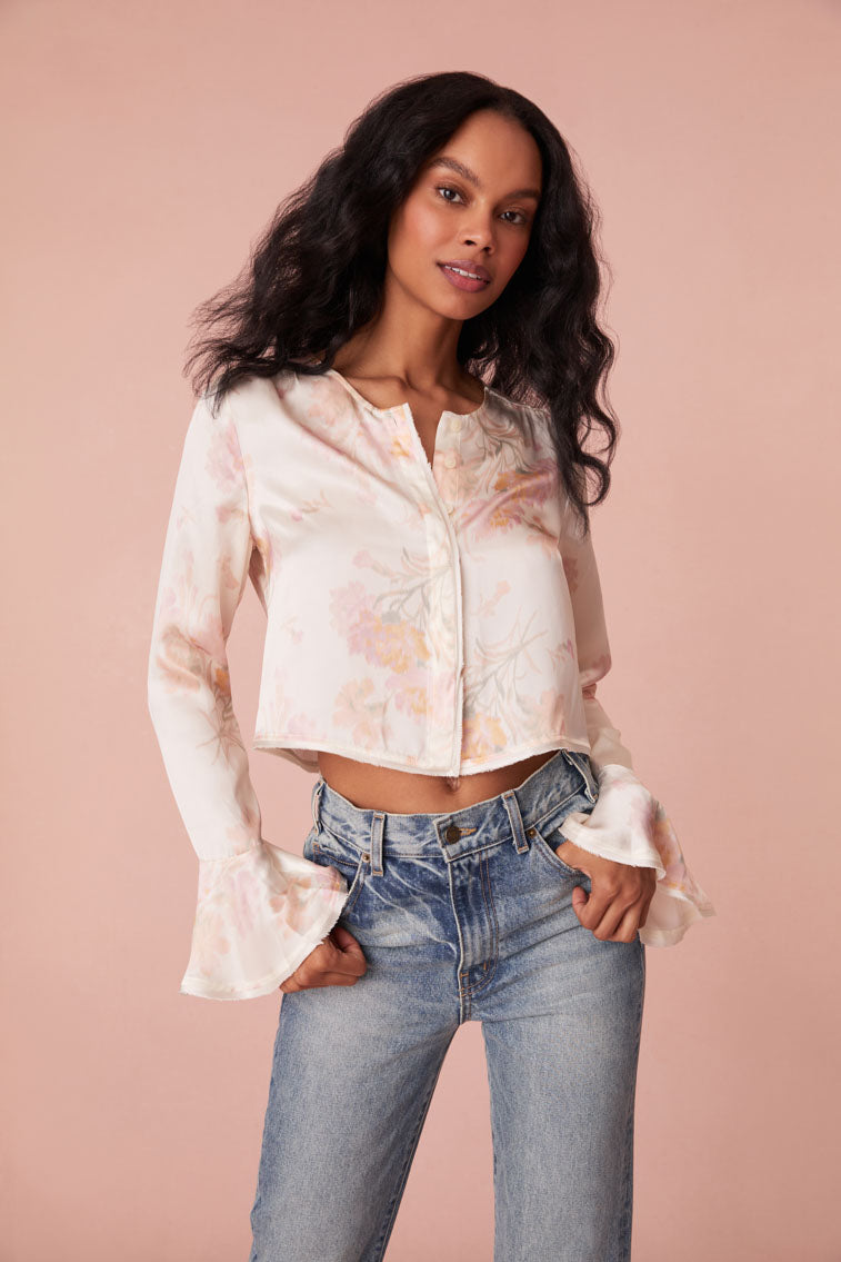 Floral top with long bell sleeves and our custom LoveShackFancy buttons down center front.