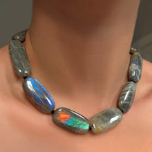 Labradorite Long Oval Necklace with black thread on a model's neck.