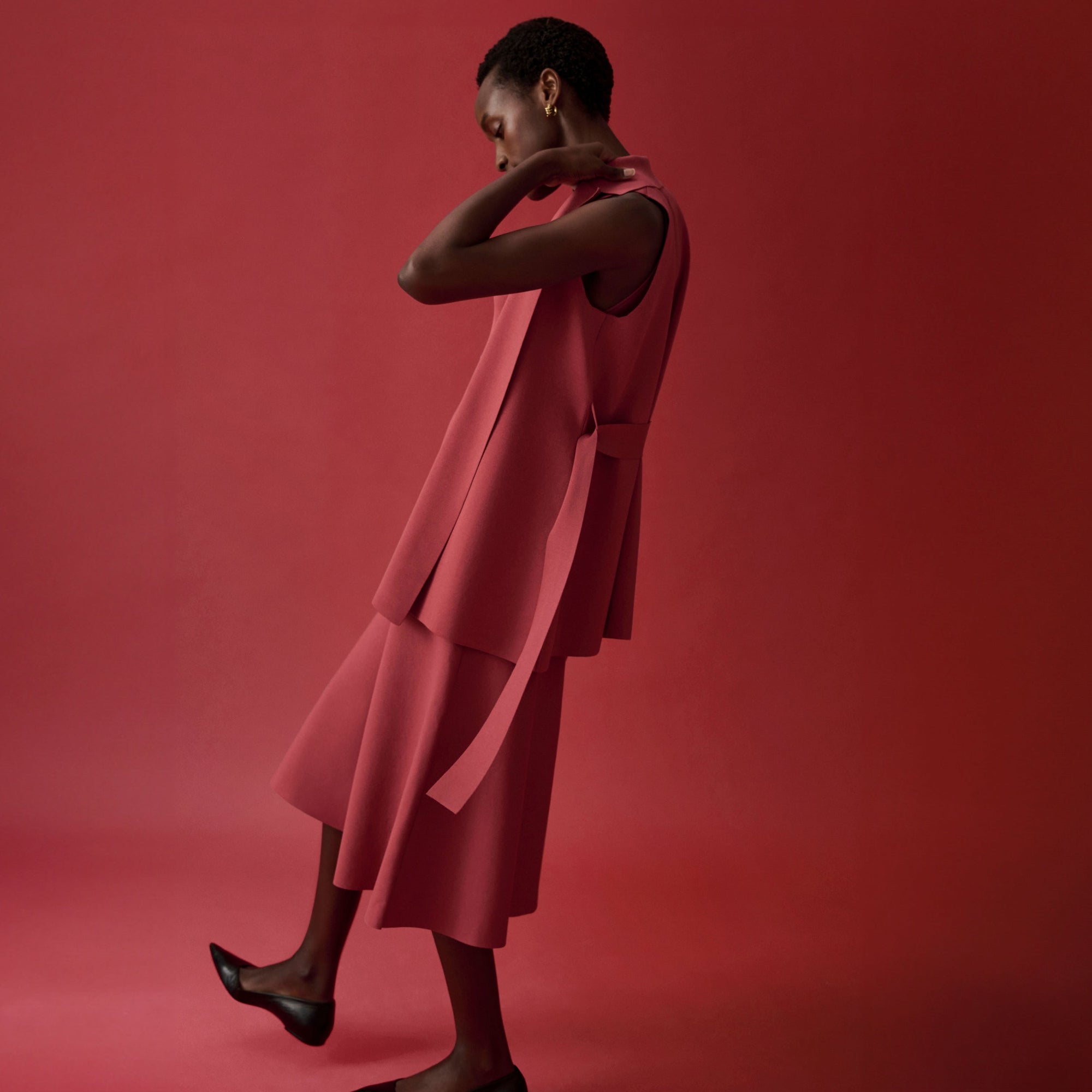 side image of a woman wearing the anh jardigan in carnation