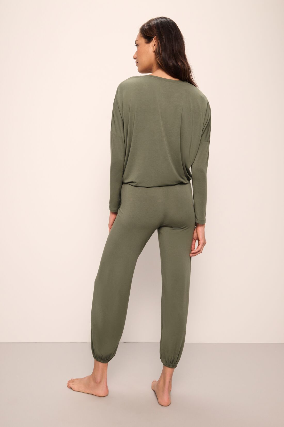 Model wears Gisele TENCELâ„¢ Modal Slouchy PJ Set in moss/ivory.