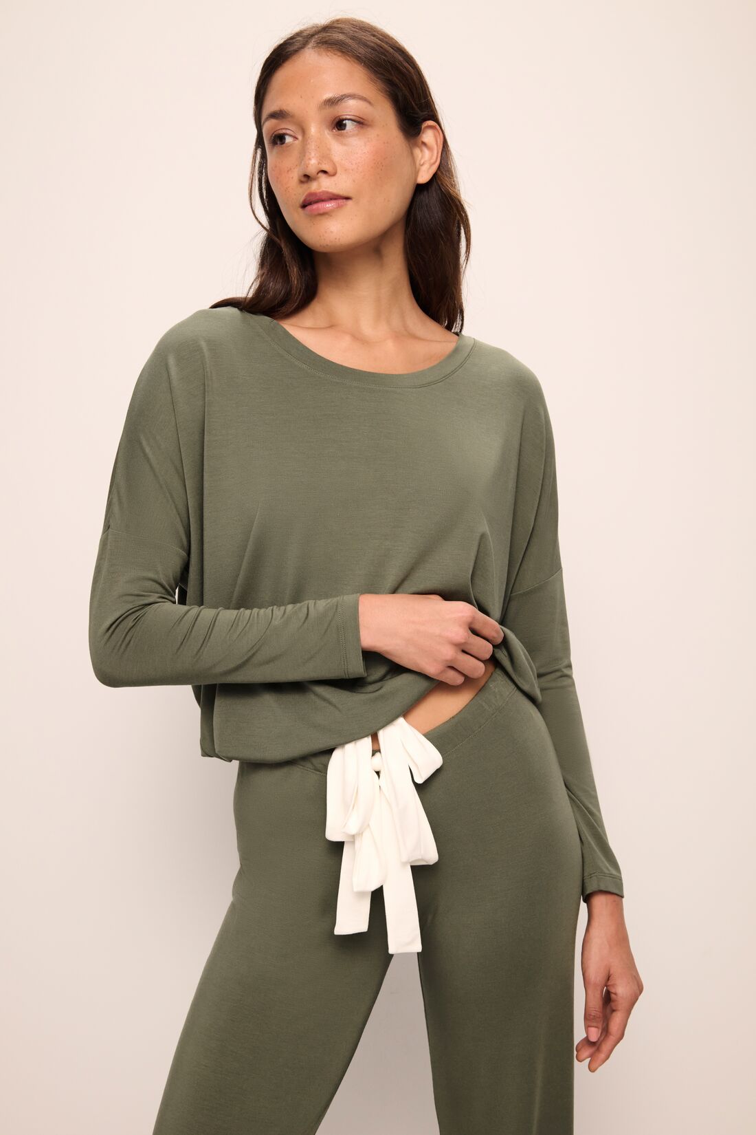Model wears Gisele TENCELâ„¢ Modal Slouchy PJ Set in moss/ivory.