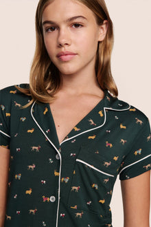 Model is wearing Gisele Printed TENCEL Modal Shortie Short PJ Set in Holiday Dog Pine/Ivory