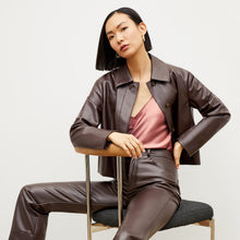 Front image of a woman wearing the nicky jacket in brown