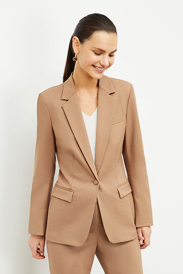 Front image of a woman standing wearing the Yiyan Blazer in Camel | Exclude | Grid