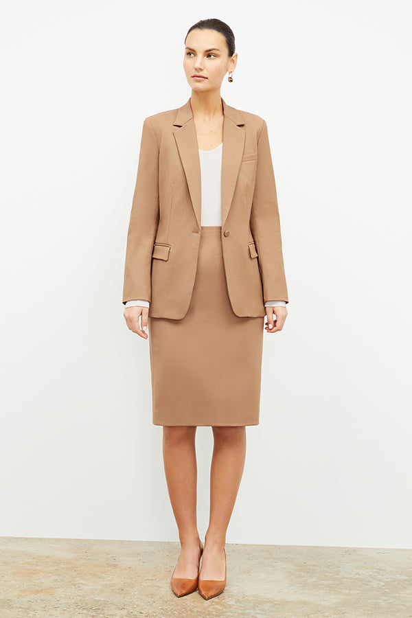 Front image of a woman standing wearing the Yiyan Blazer in Camel | Exclude