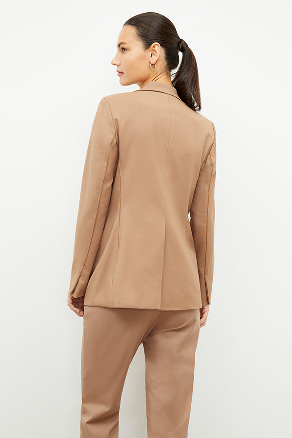 Front image of a woman standing wearing the Yiyan Blazer in Camel | Exclude | Grid Hover