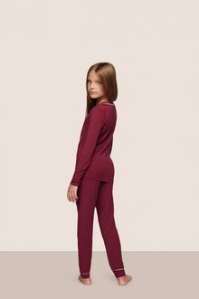 Model is wearing Kids TENCEL Modal Unisex Long PJ Set  in Bordeaux/Ivory