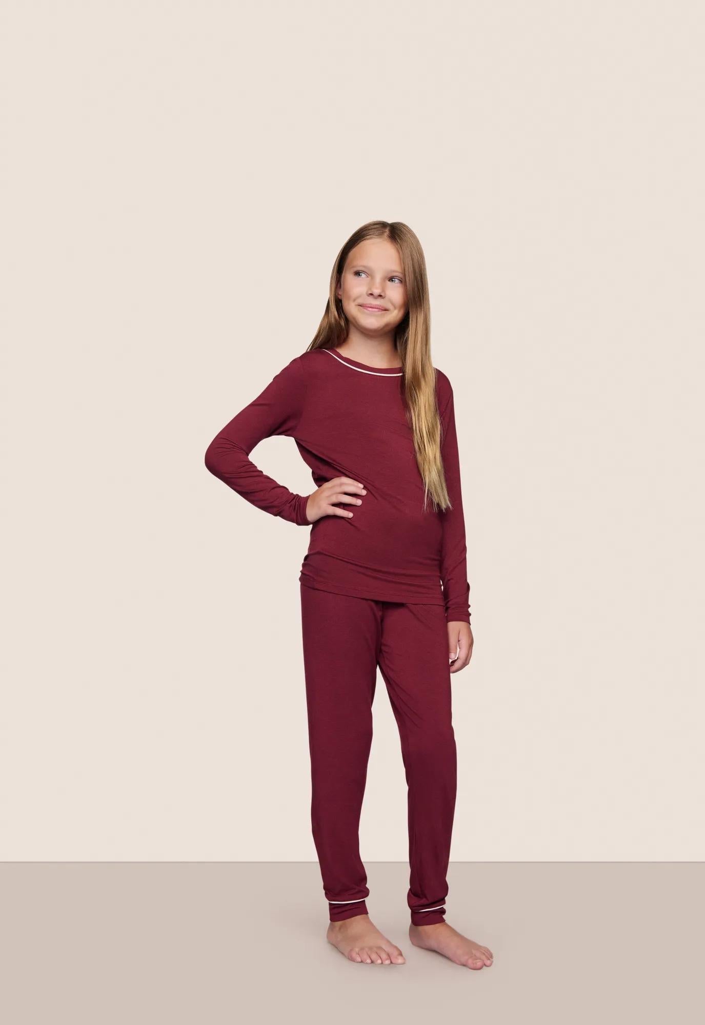 Model is wearing Kids TENCEL Modal Unisex Long PJ Set  in Bordeaux/Ivory