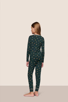 Model is wearing Kids Printed TENCEL Modal Unisex Long PJ Set  in Holiday Dogs Pine/Ivory