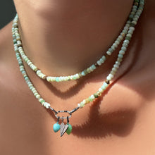 Peruvian green faceted opal necklaces layered on the neck with a medium pave face charm lock with chrysoprase and amazonite drop charms and a full pavé folded heart charm.