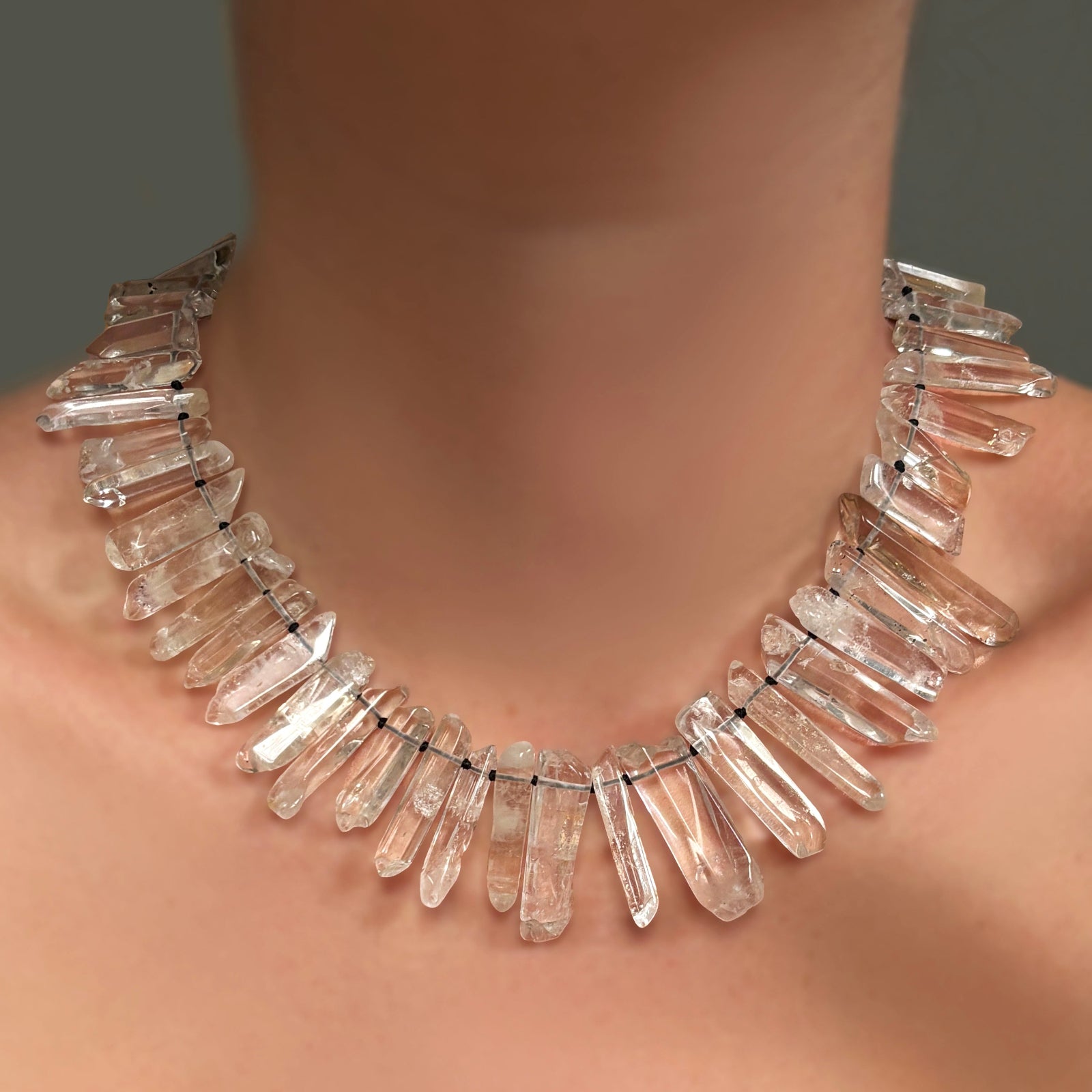 Rock crystal collar on a model's neck.