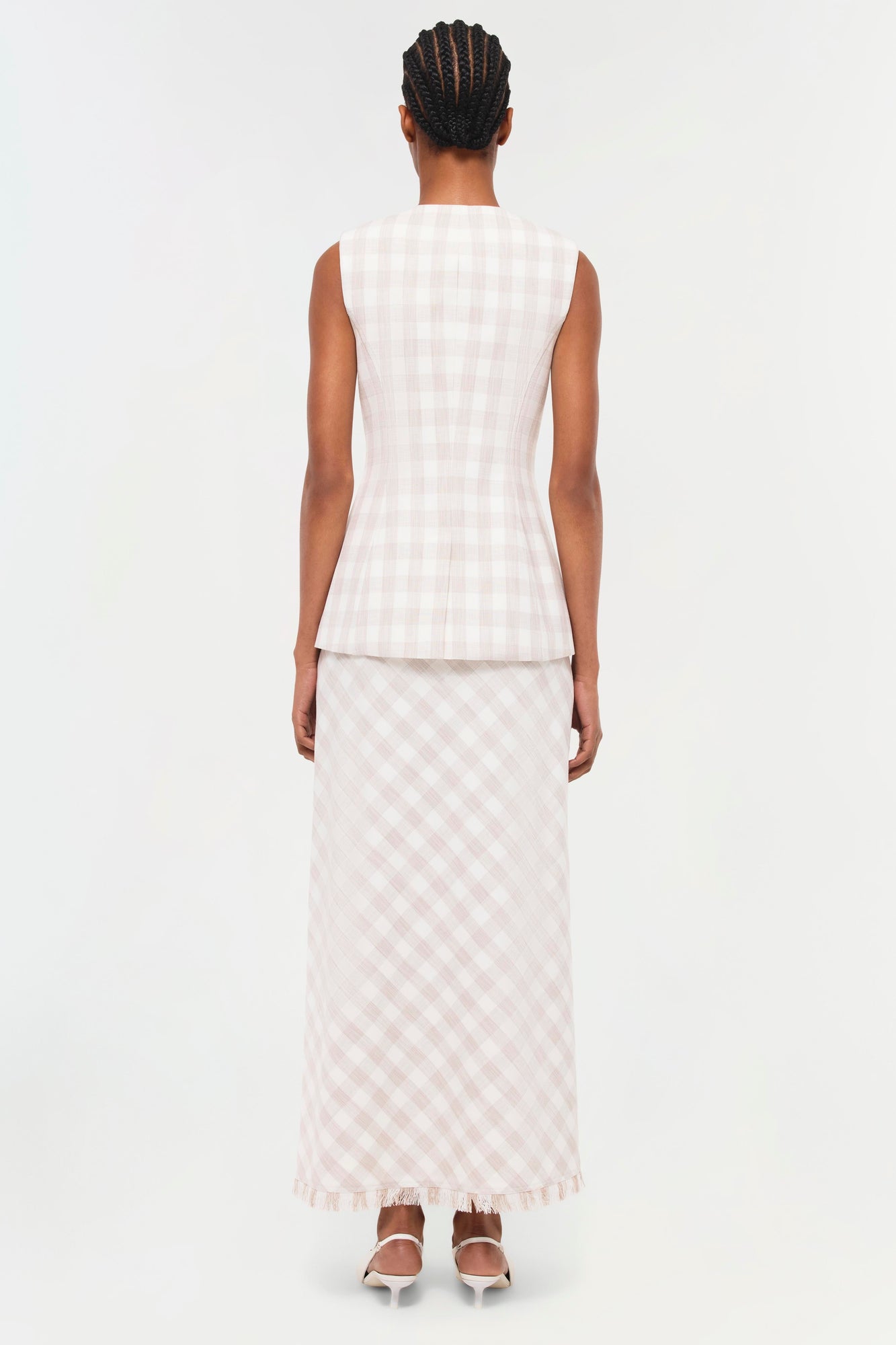 Sleeveless white gingham check vest with vertical ribbed texture, shown from back view on model.
