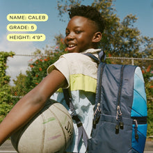 5th grade boy smiling holding a basketball wearing state bags kane kids  large blue chevron backpack