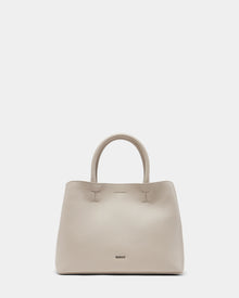 The CATIRA S - 8325006 Vanilla by Rudsak is a beige womens pebble leather tote with two rounded handles, subtle stitching, a removable shoulder strap, and the brand name near the bottom, shown upright on a plain light background.