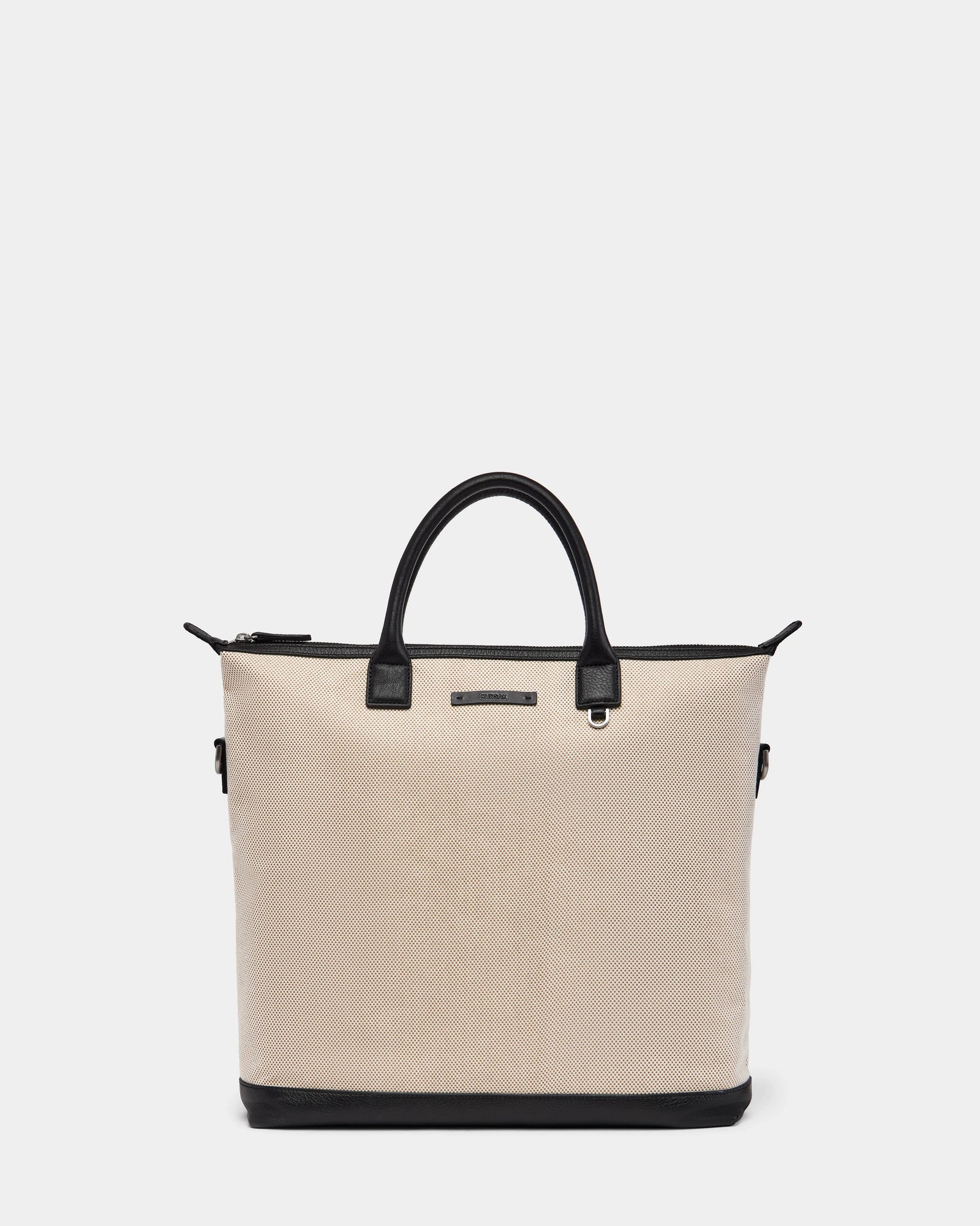 The DEXTER - 9324513 Vanilla by Rudsak is a beige textured canvas tote with black leather handles, black trim, and base. Featuring a zipper closure and front metal label, this unisex bag is a versatile accessory for any occasion.