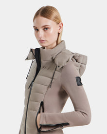 A woman poses for a picture, showcasing the Rudsak MABS - 8124825 Cement jacket, a stylish lightweight piece that adds a modern touch to her outfit.