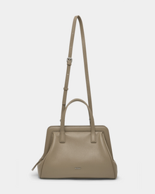 The Rudsak TAULLA - 8325002 Almond is a taupe pebble leather women’s satchel with double handles and a removable shoulder strap, subtle silver hardware, a small logo front, and a roomy interior for daily essentials.