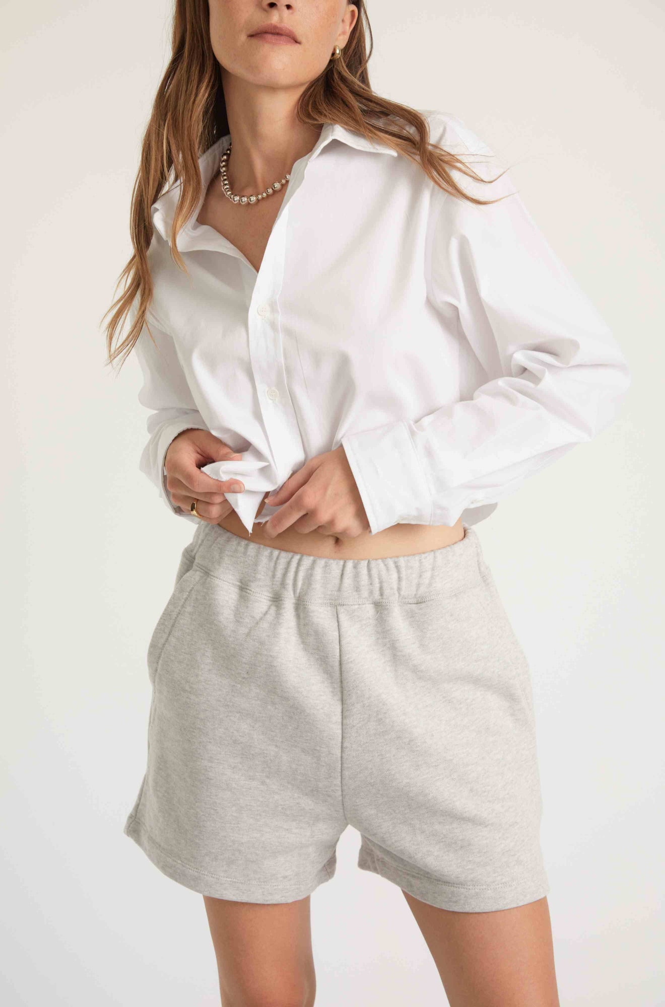 Woman wearing grey sweatshorts