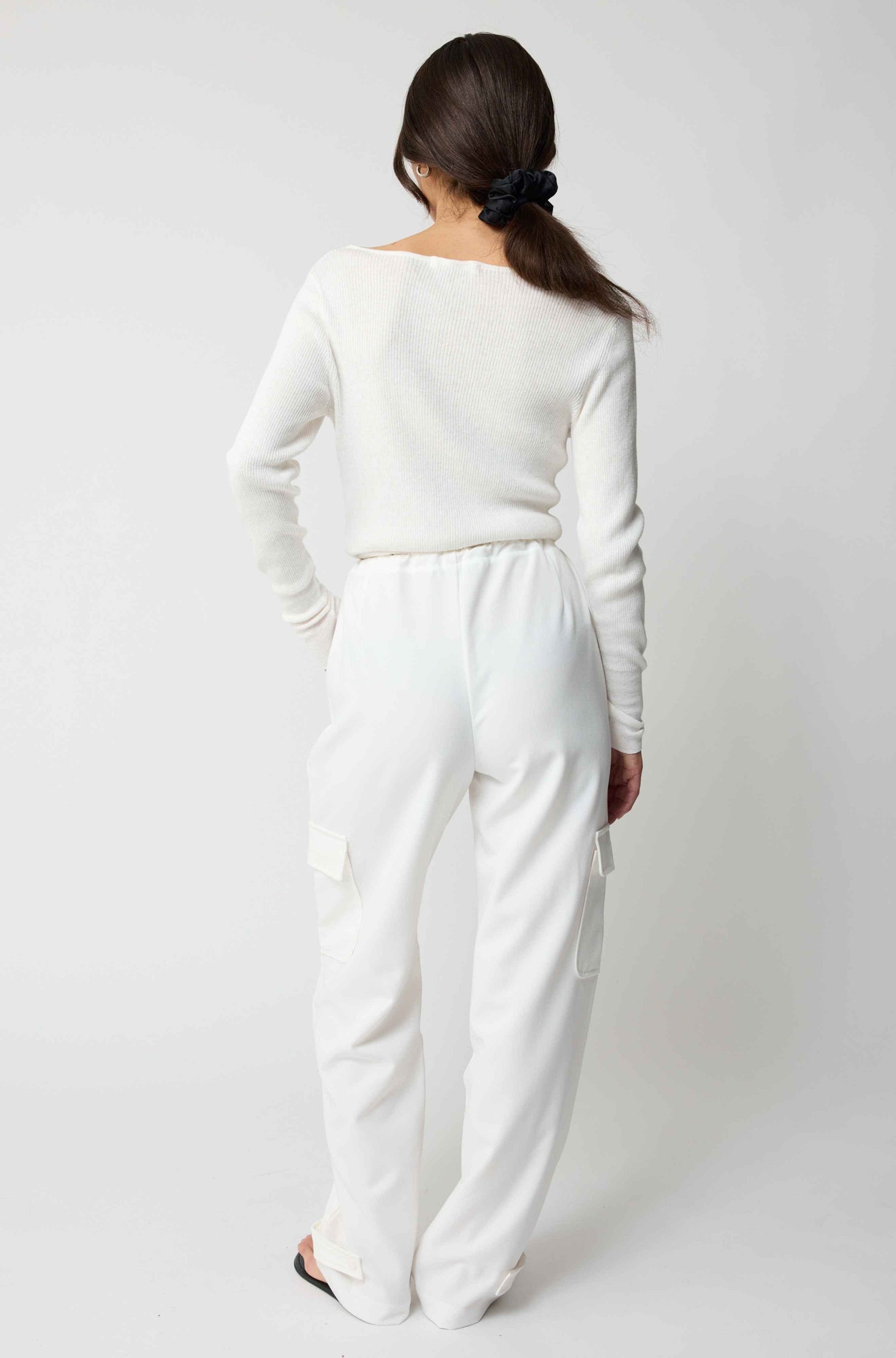 Person wearing a white outfit on a plain background