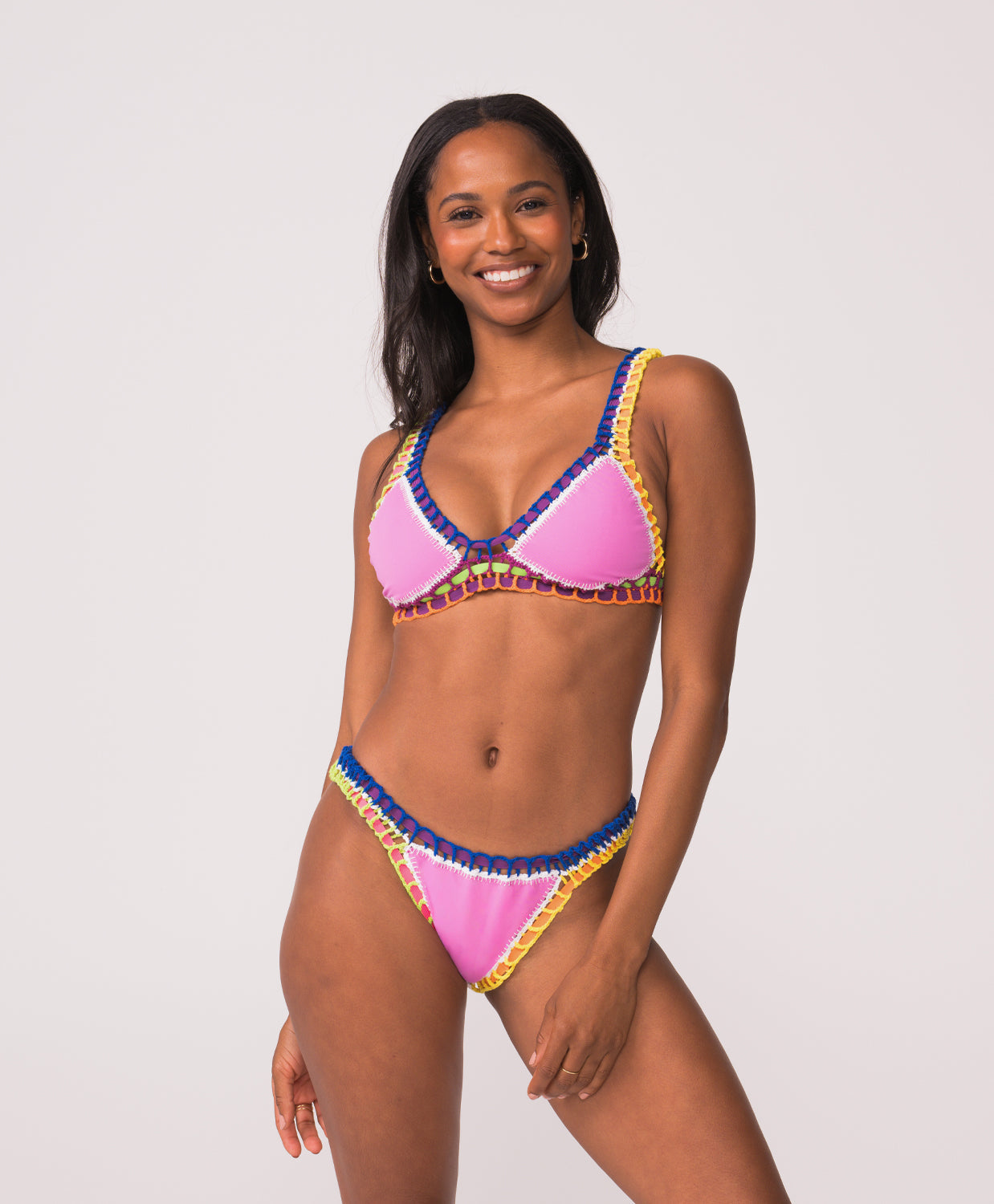 Woman wearing a colorful bikini with a white background