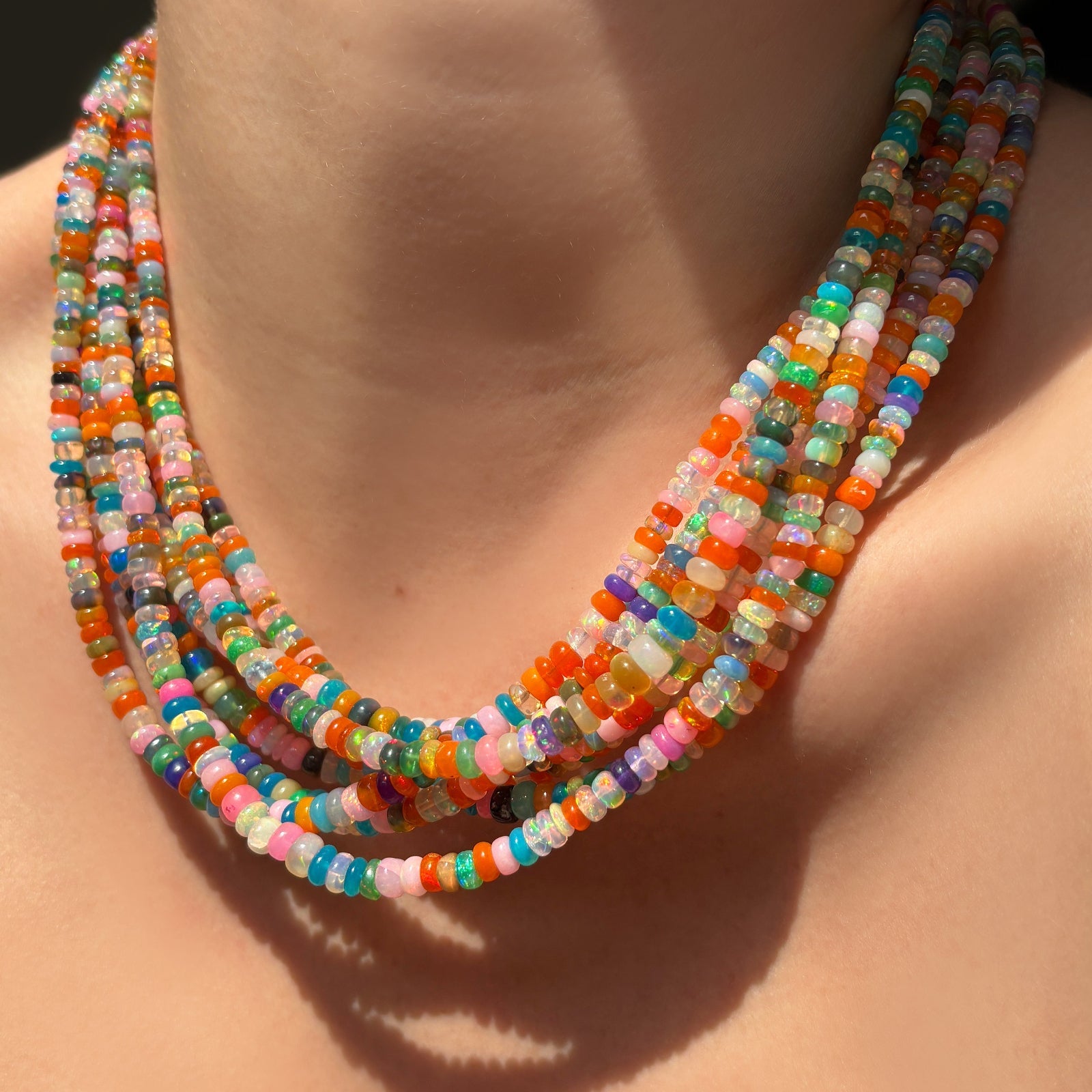 Desert disco multi colored opal necklaces layered on the neck.