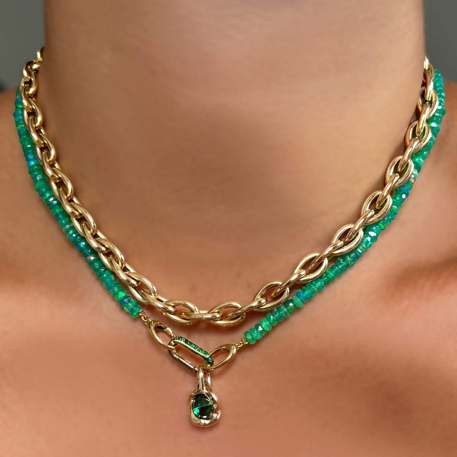 Green faceted opal necklace paired with the small emerald charm lock and the molten knot charm. Layered with the drop link chain necklace.