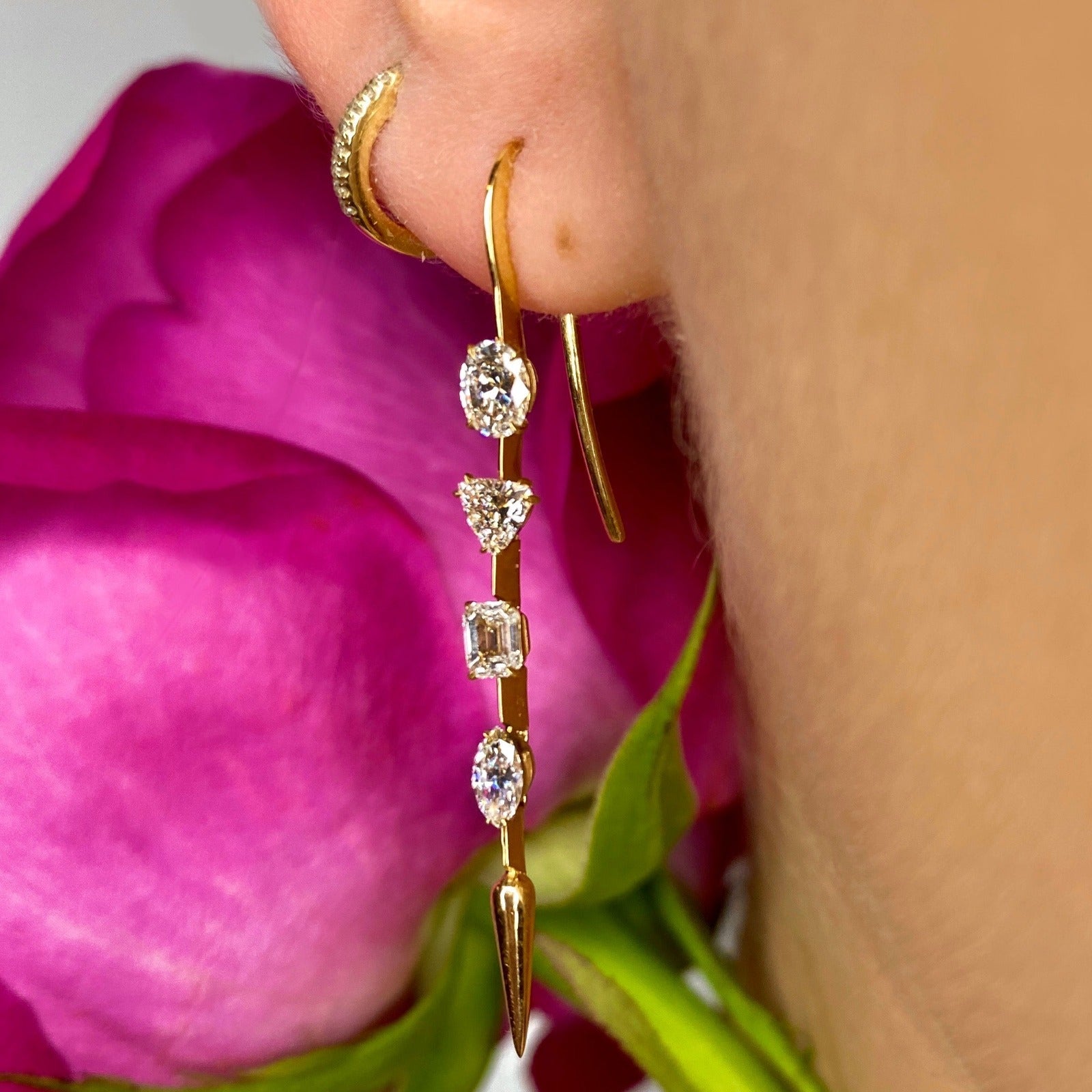 14k gold Diamond Drop Earrings with emerald cut, cushion cut, trillion cut, Pear cut, baguette cut diamonds styled on an ear