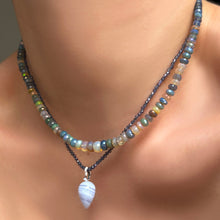 Iolite slim gemstone necklace with blue lace agate drop charm with ripple bale, layered with a galaxy faceted opal necklace on a model's neck.