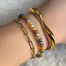 Bracelet stack with a molten cuff, galaxy faceted opal bracelet, and chunky paperclip chain bracelet.