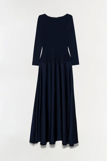 Navy satin knit gown with long sleeves, round neckline, and full-length pleated skirt.