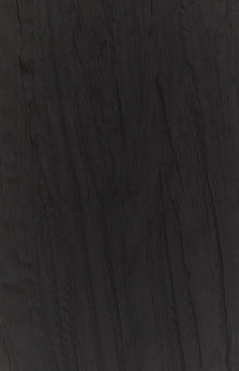 Close-up of the black sheer crinkled fabric texture of the maxi skirt