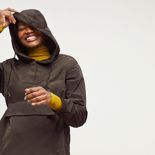 Front image of a woman standing wearing the Britt Hoodie—AirTech in Dark Moss | Exclude